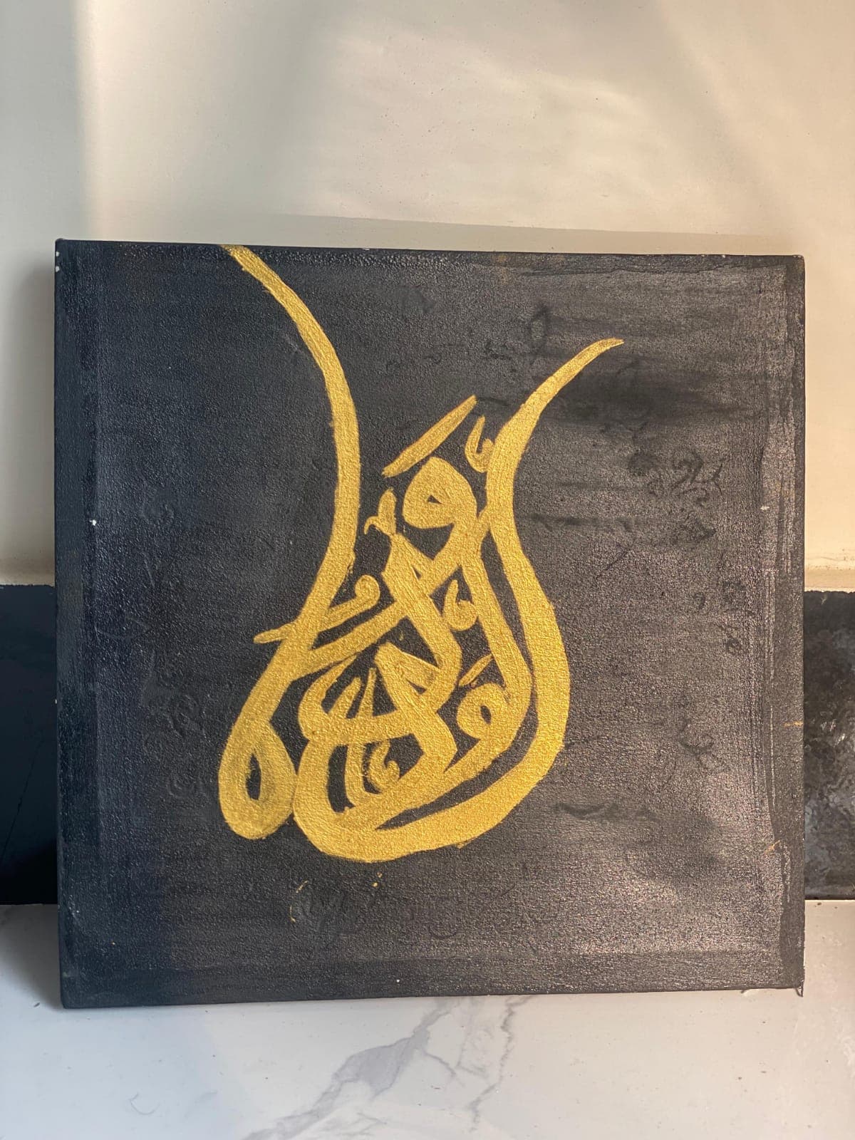 Gold calligraphy artwork in progress