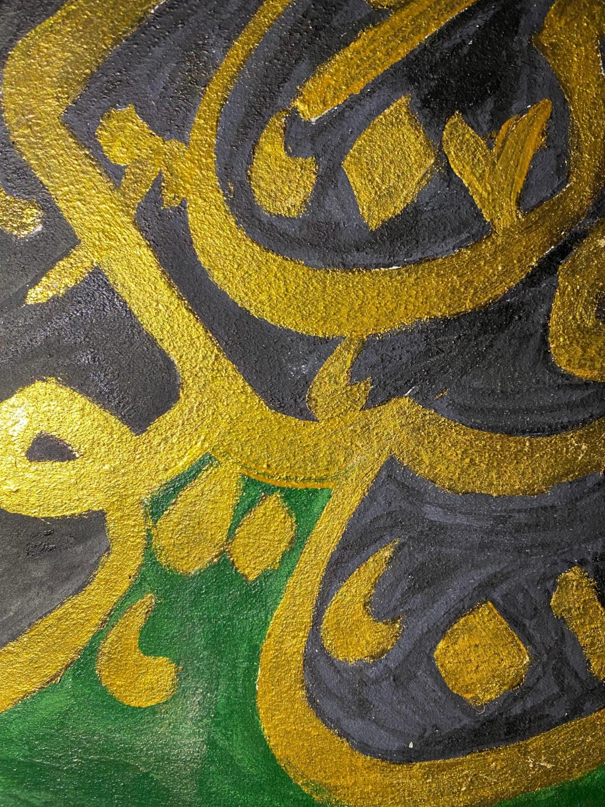 Detail of gold calligraphy brushwork over green and black